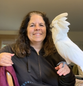 Sharyn B. Marks with a white bird on her hand